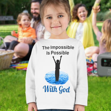 Rabbit Skins toddler long-sleeve t-shirt with “Impossible Toddler” design and faith-filled message, soft cotton, breathable and durable, Christian apparel for active toddlers and spiritual encouragement, toddler girl in white shirt